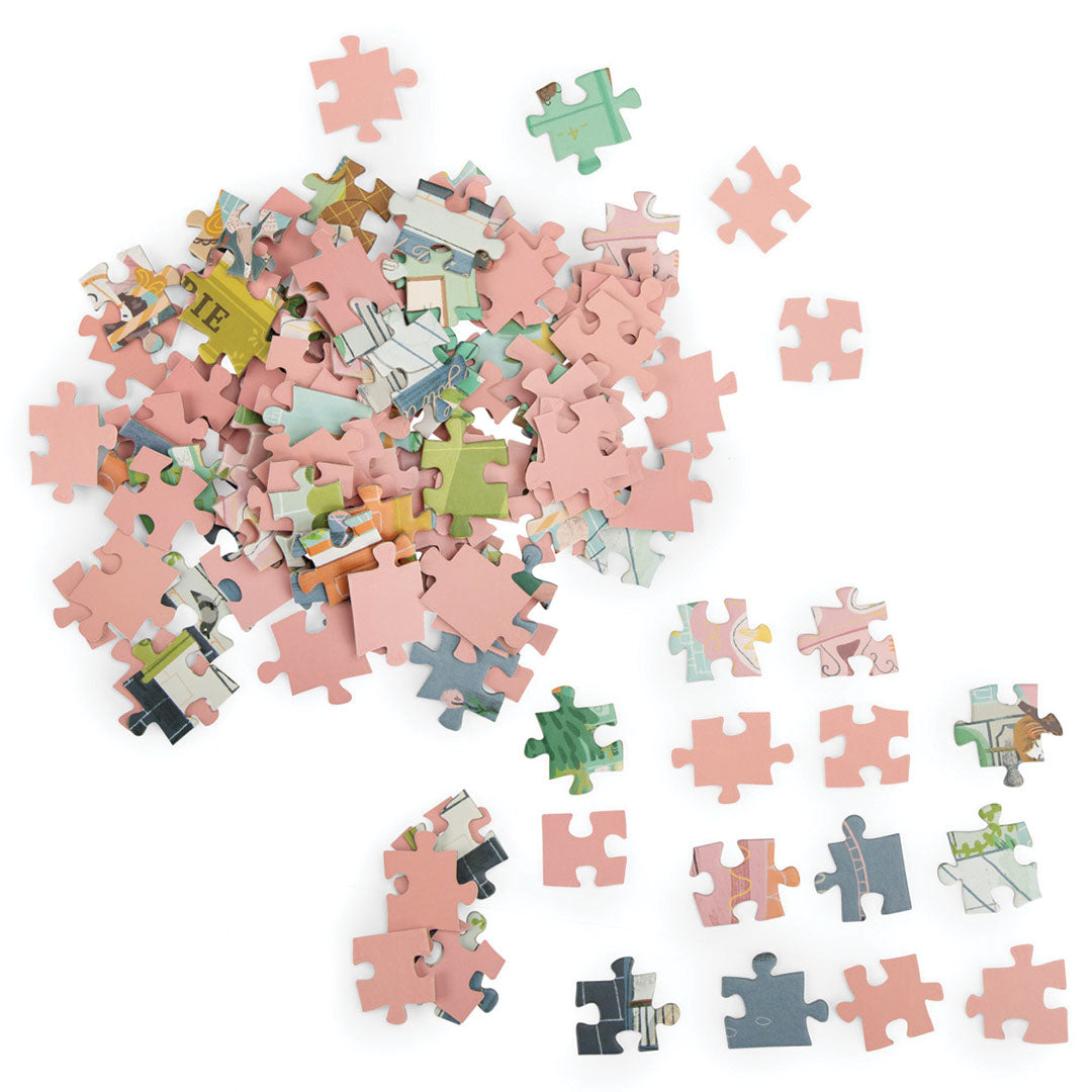 Een stapel roze en gekleurde puzzelstukjes, waarvan sommige delen van de stadsgezicht illustratie tonen.
